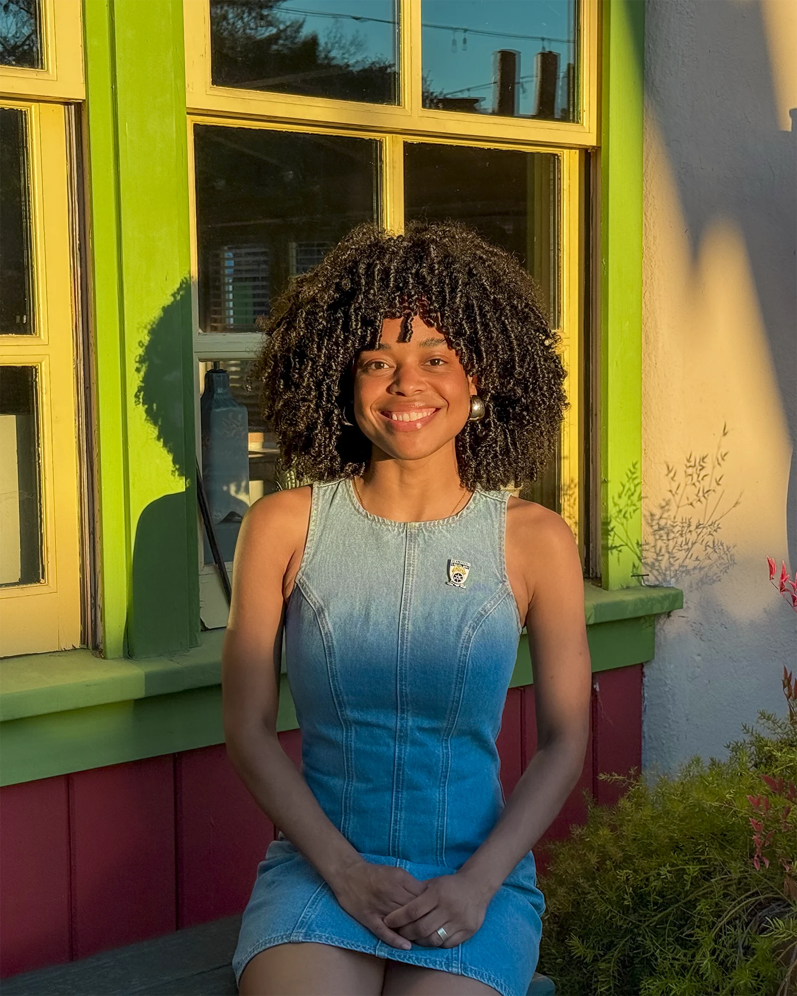 Savannah Luraya Soto stands smiling in a village walkway.